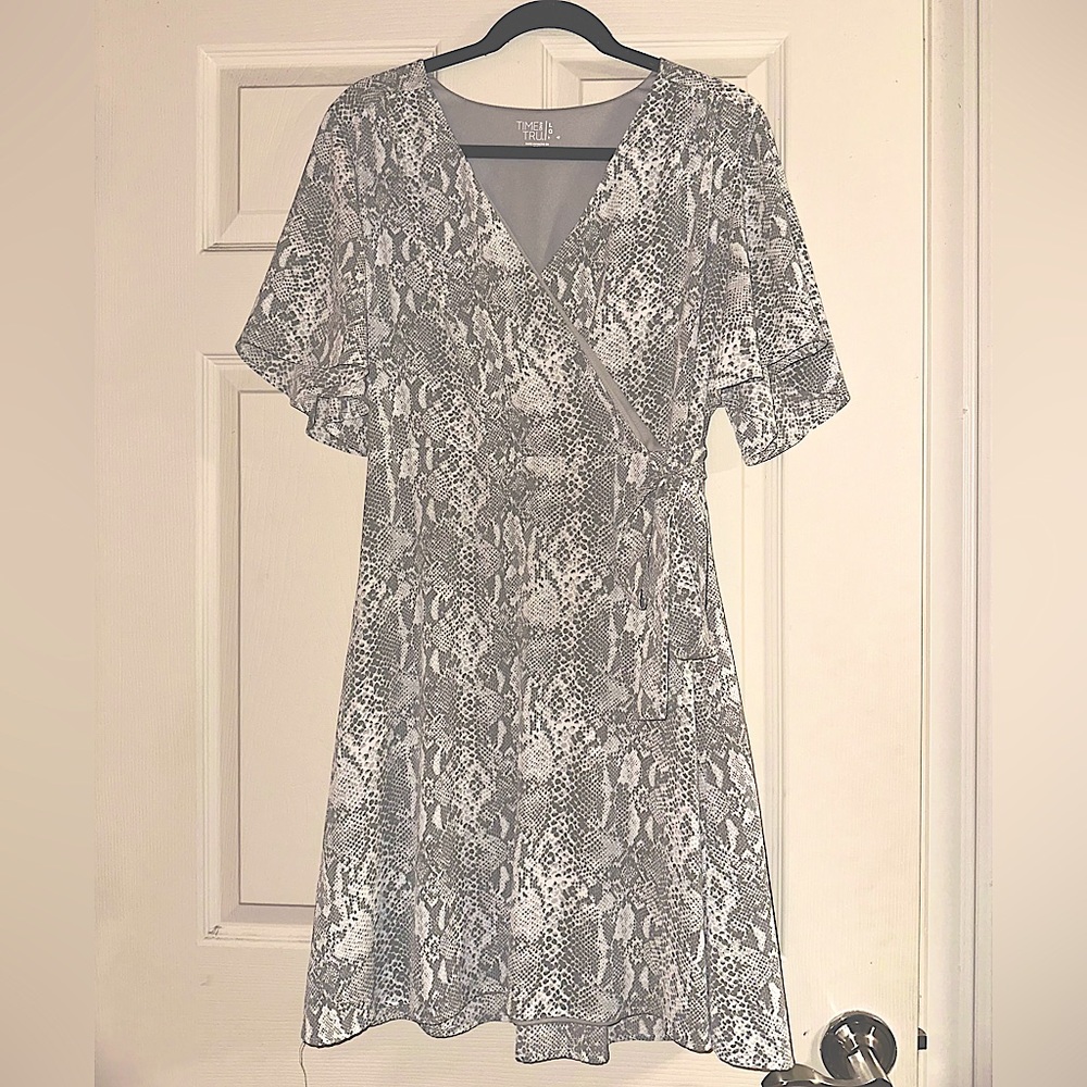 Women’s snake print dress with flattering flutter sleeve.